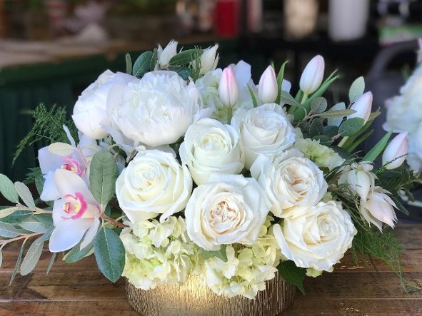 Floral centerpiece, tulips, peonies, garden roses, orchids, guava leaves, blushing bride protea