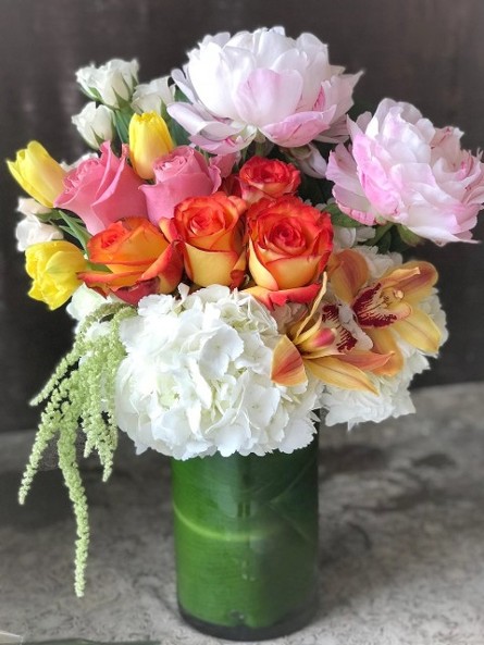 Floral arrangement of hydrangeas, roses, orchids, peonies and tulips